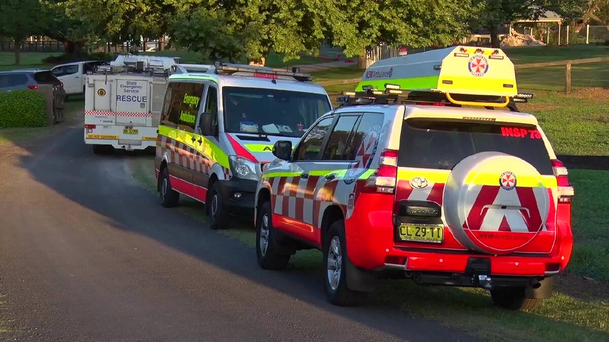 Emergency services vehicles wait for the man to get safely back to the shore. Picture: TNV.