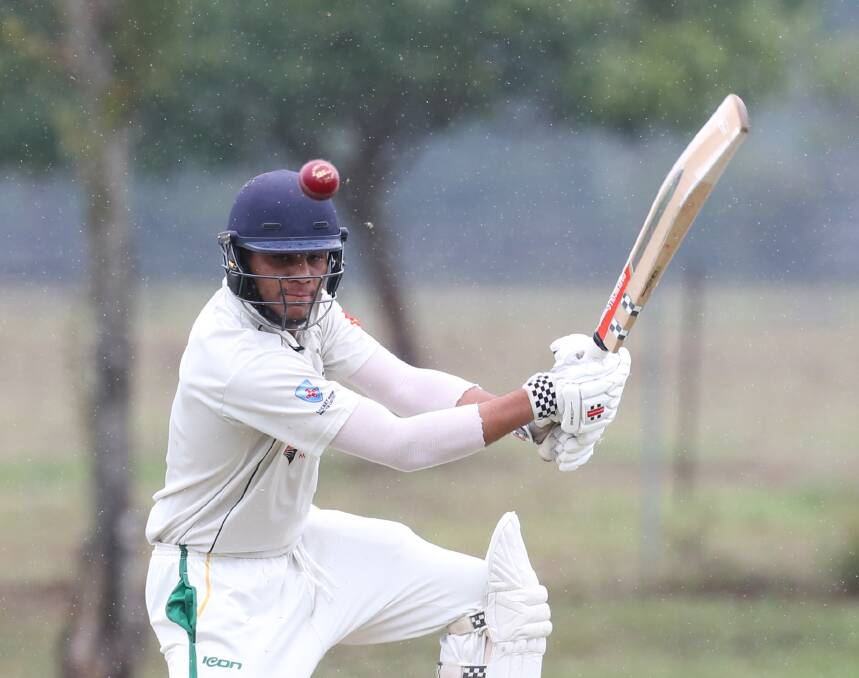 Rainy match: Hawkesbury's Abhijeet Dandyan faces a ball in the rain in the 4th Grade Premier Cricket match against Fairfield on Saturday at Richmond. Some weekend matches were cancelled due to the weather. Picture: Geoff Jones.