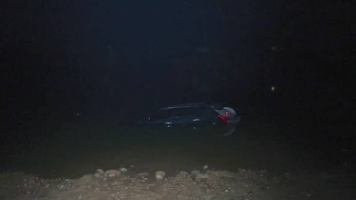 Submerged: The car in the Hawkesbury River on the night of the crash. Picture: TNV.