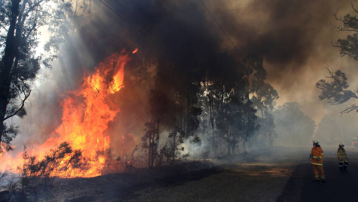 Warning: NSW Fire and Rescue and the Rural Fire Service work to bring under control a bushfire in the vicinity of Londonderry last month. A catastrophic fire danger rating has been issued fro tomorrow (Tuesday) for the first time. Picture: Geoff Jones.