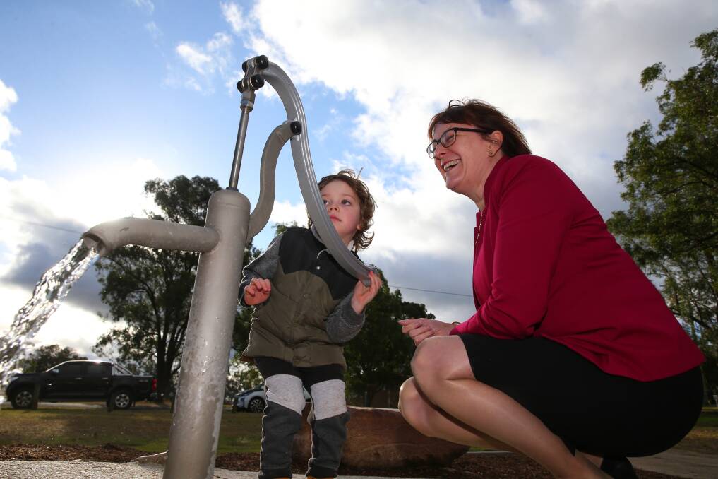 Macquarie MP Susan Templeman is shown how to operate the water pump by one of the young attendees on the day.