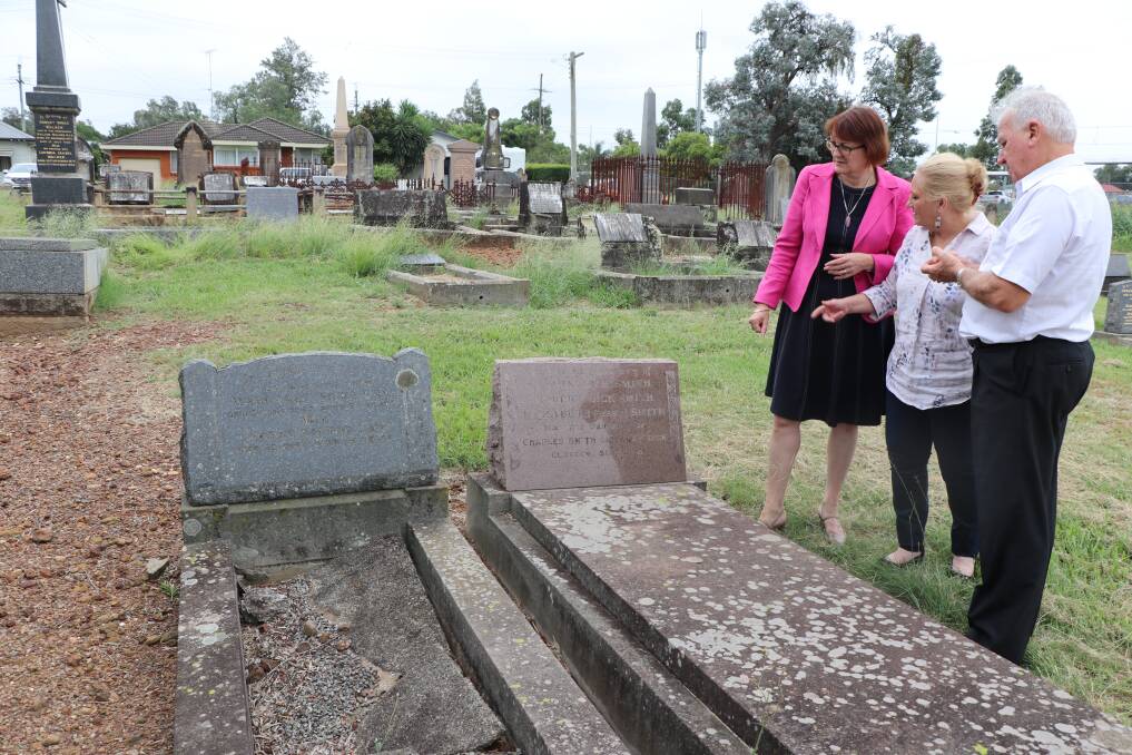 Flashback: Susan Templeman, Mary Lyons-Buckett and Alan Leek standing next to John Smith's grave, the only person to attend Mr Whirpool's funeral, in February.
