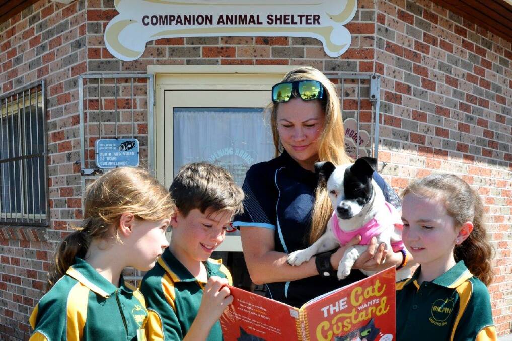 Teaching compassion: Children from Bilpin Public School with Dannii Warner and a furry friend at the Hawkesbury Companion Animal Shelter. Picture: Supplied.
