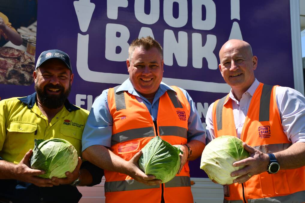 Partnership: Demonstration Farm Manager Ben Conasch with Ben Cox and John Robertson of Foodbank NSW and ACT. Picture: GSLLS.