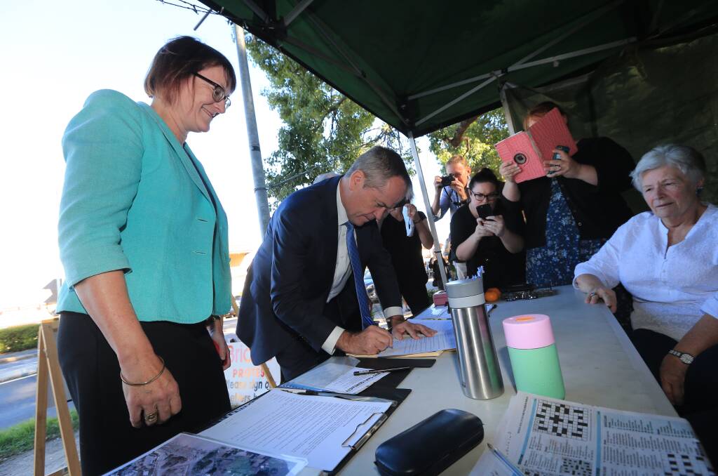 Flashback: Opposition leader Bill Shorten signs CAWB's petition at Thompsons Square last year. CAWB plans to renew its application for the tent in January. Picture: Geoff Jones.