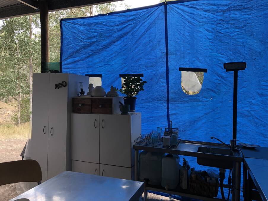 Brian the goat, possums, echindas and birds all visit the open kitchen which is partially protected from the elements by tarps. Photo: Ainslee Dennis.