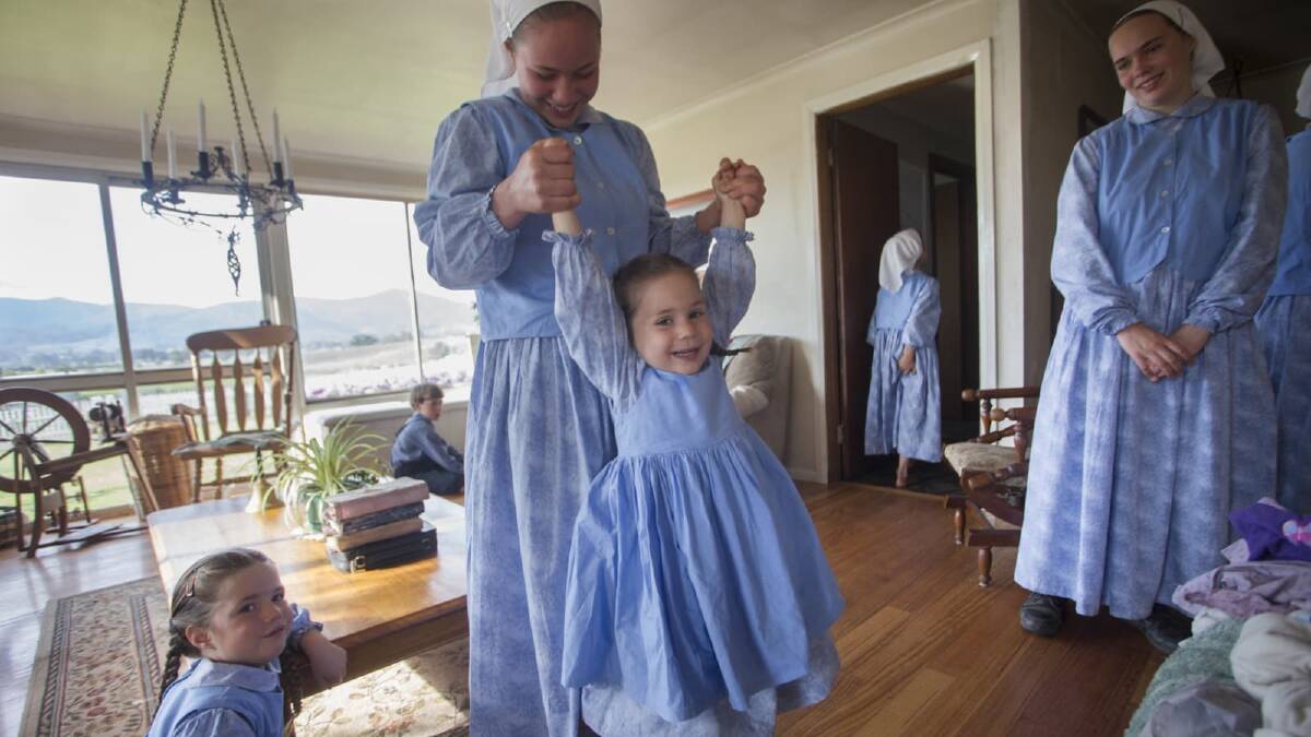 Elizabeth and Abi have fun before chores start; Ruth and Esther look on. Picture: MEREDITH O'SHEA