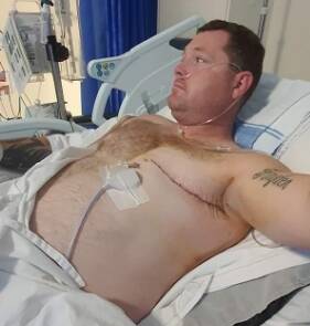 Josh Crew recovers in hospital after his full left mastectomy.