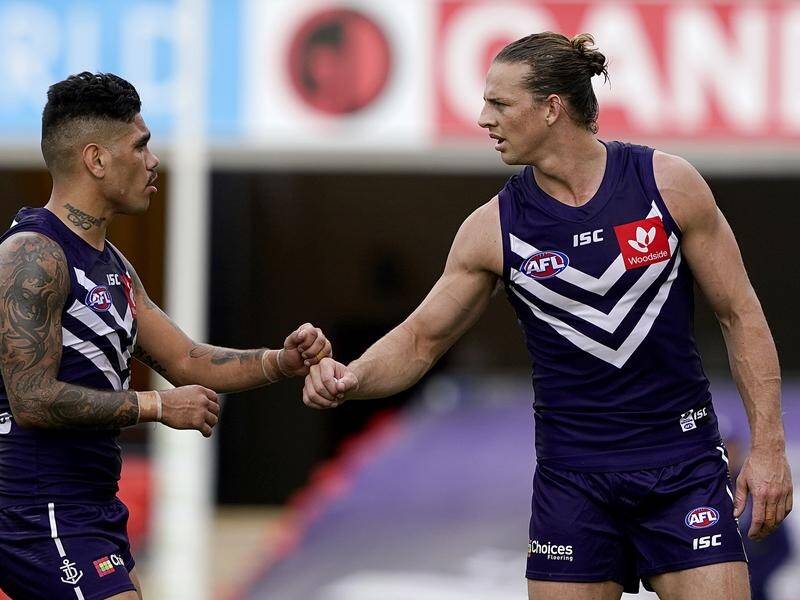 Fremantle ace Nat Fyfe (r) faces a fitness test on a hamstring before he can play West Coast.