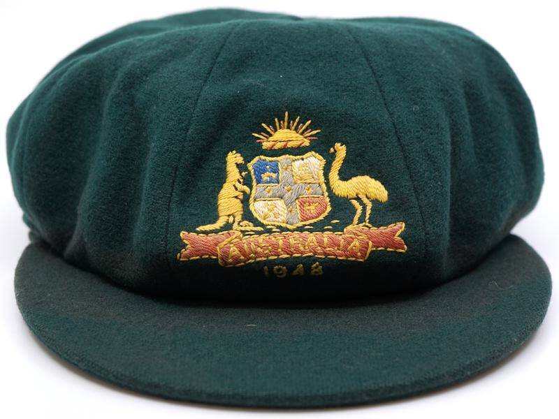 Arthur Morris's baggy green will be auctioned online along with fellow Invincible Sam Loxton's cap.