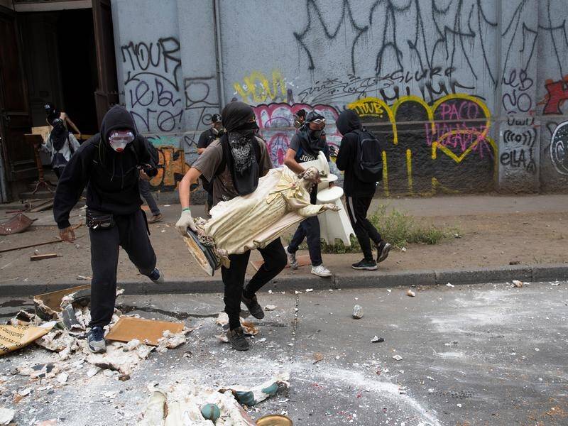 Chilean protesters loot a Catholic church during a protest against the government in Santiago.