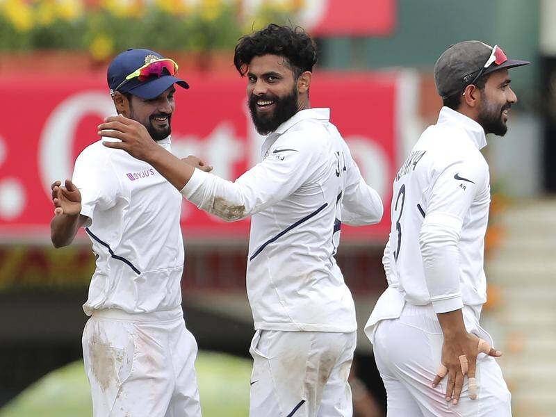 India's Ravindra Jadeja (c) celebrates with teammates after a South Africa wicket in the third Test.