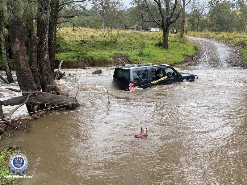 A four-year-old boy and two women were rescued after their vehicle was caught in flooding in NSW. (PR HANDOUT IMAGE PHOTO)