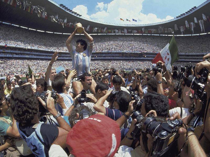 The late Diego Maradona lifting the World Cup to the skies in Mexico City 1986.