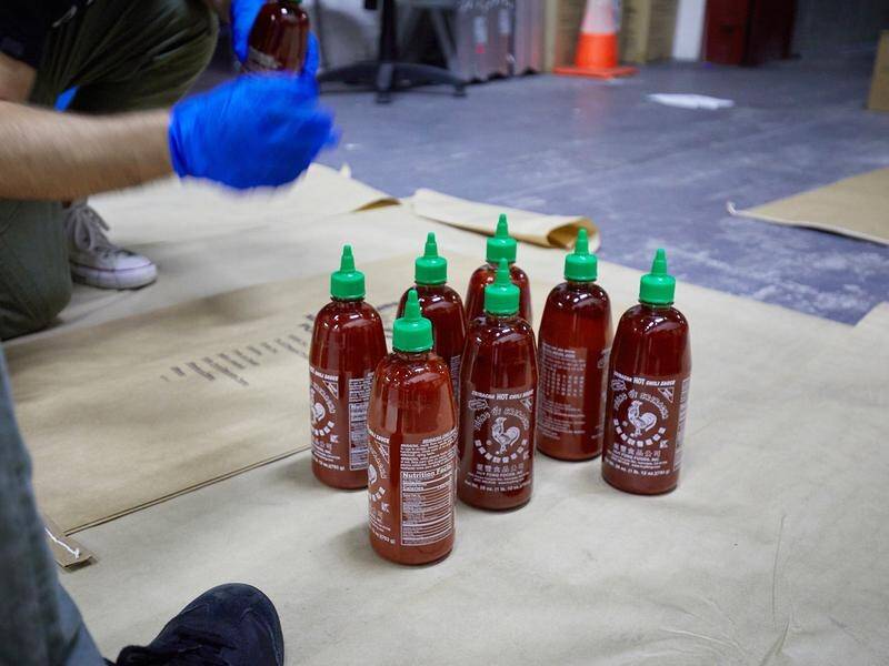 Two more men have been charged over a $300 million 'ice' shipment hidden in chilli sauce bottles.