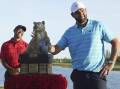 World Hero Challenge winner Scottie Scheffler with the trophy, as Tiger Woods looks on. (AP PHOTO)