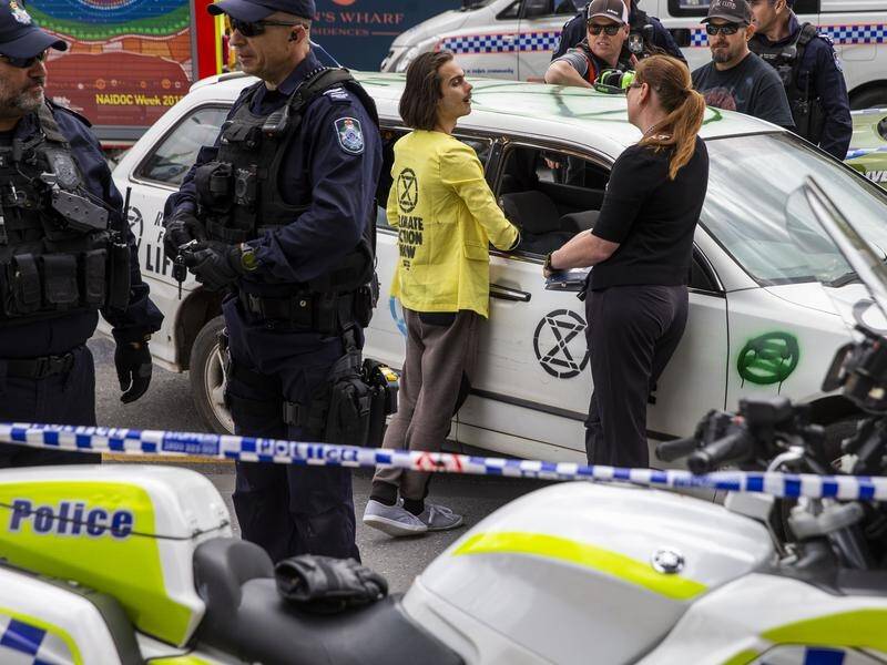Extinction Rebellion activist Eric Herbert was arrested after being cut from a car in Brisbane.