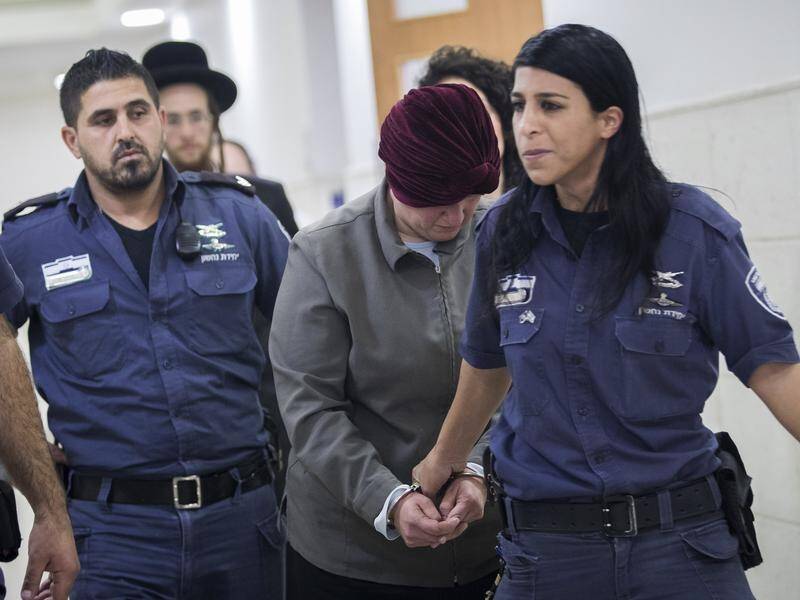 An Israeli judge has ruled Malka Leifer (C) poses a flight risk and should remain behind bars.