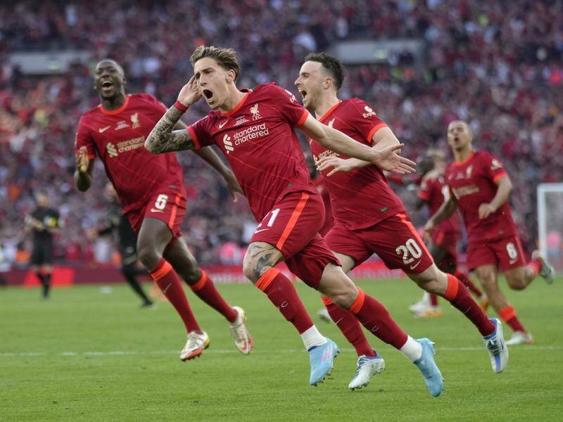 Liverpool joyous players chase Kostas Tsimikas after his winning penalty in the shootout.