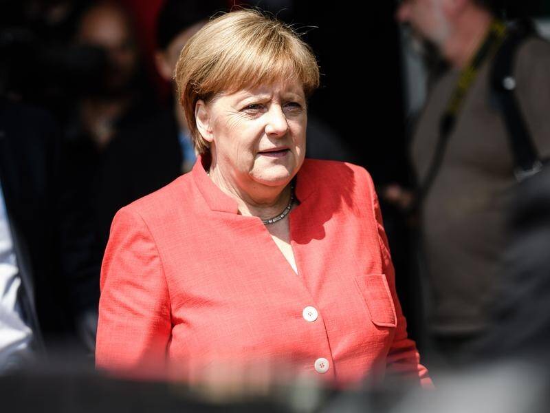 Merkel is facing criticism at home and abroad as she tries to hold together her fractious coalition.