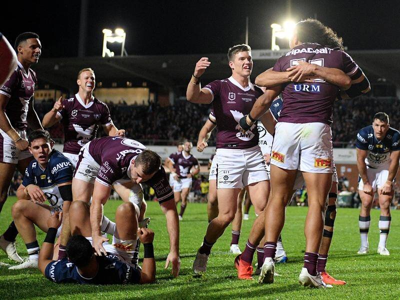 Manly celebrate one of their nine tries in a big NRL win over North Queensland.