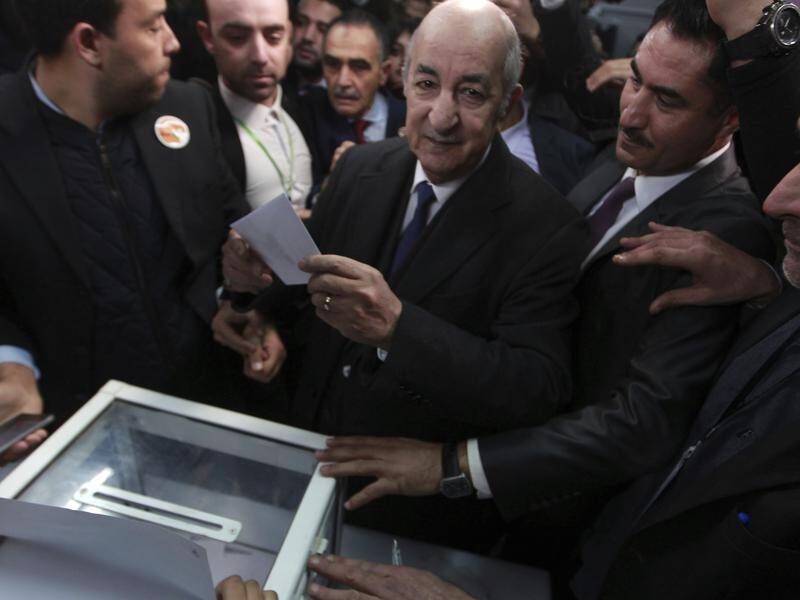Presidential candidate Abdelmadjid Tebboune casts his ballot in Algeria's election.