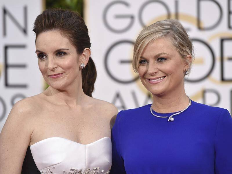 Amy Poehler (right) has and Tina Fey will return to host the Golden Globes in 2021.