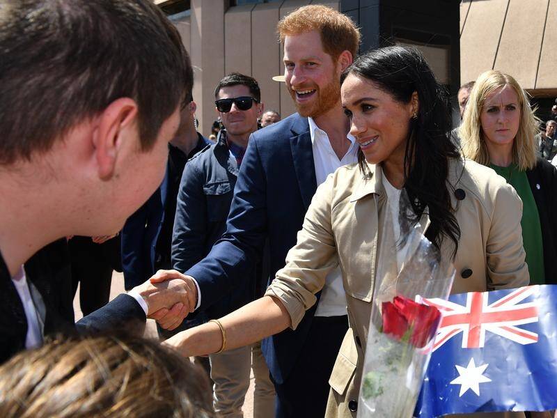 Prince Harry and Meghan have been warmly welcomed by thousands of fans at the Sydney Opera House.