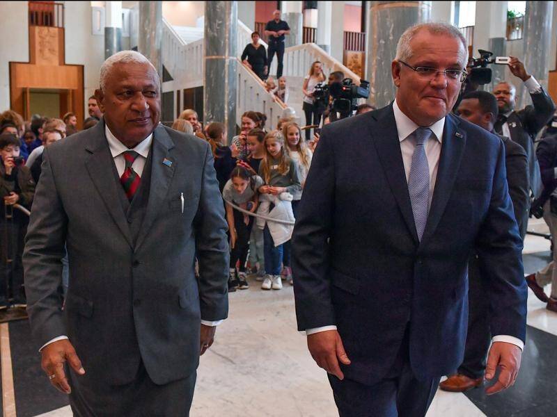 Morrison has focused on kava and rugby in his discussions with Fijian PM Frank Bainimarama (L).