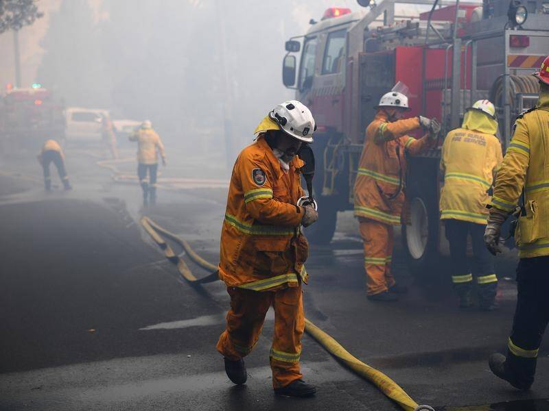 Two people have died and seven people are missing as bushfires rage in NSW and Queensland.