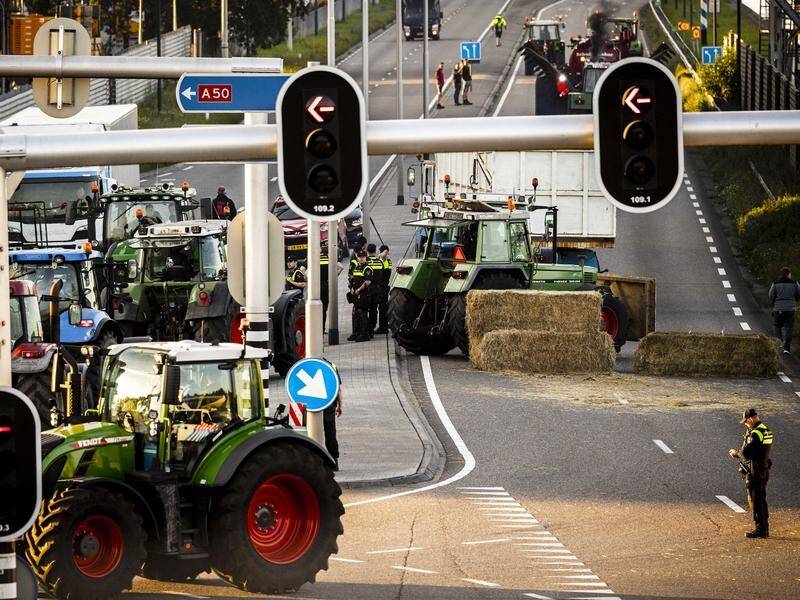 Farmers have used tractors and bales of hay to block entrances to supermarket distribution centres.