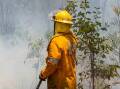 A highway has been closed and caravan park evacuated as crews tackle a bushfire in Tasmania. (HANDOUT/QFES MEDIA)