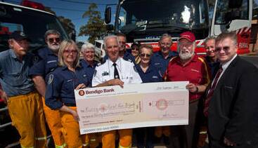 Fundraising and generous community donations enabled the extension to Kurrajong Rural Fire Brigade's shed to be built. Bendigo Bank representatives are pictured here making a donation to members of the brigade, September 21, 2013.