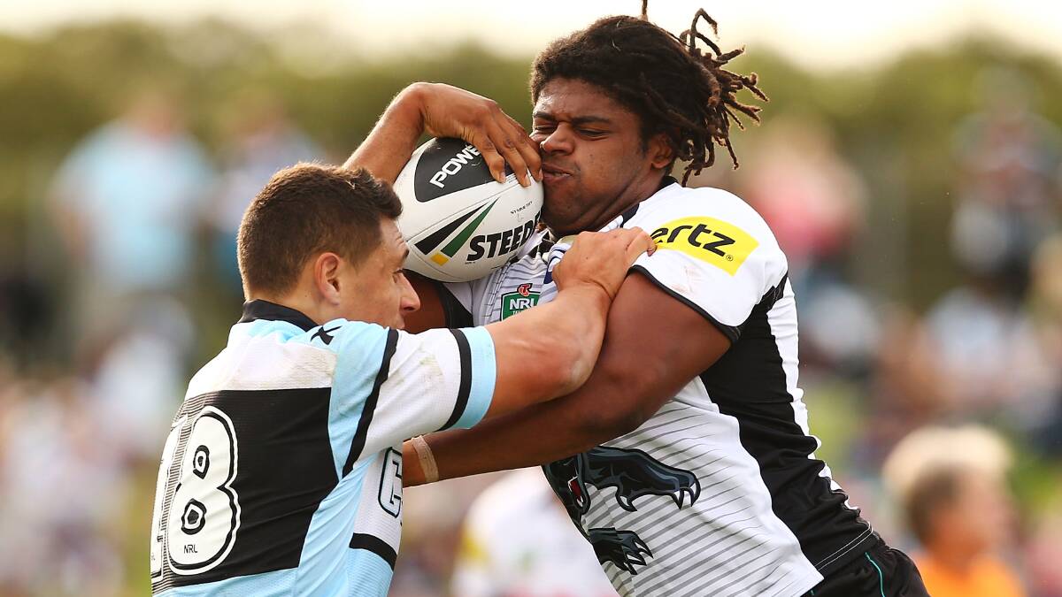 SYDNEY, AUSTRALIA - APRIL 26: Anthony Tupou of the Sharks attempts to tackle Jamal Idris of the Panthers during the round 8 NRL match between the Cronulla-Sutherland Sharks and the Penrith Panthers at Remondis Stadium on April 26, 2014 in Sydney, Australia. (Photo by Mark Nolan/Getty Images)