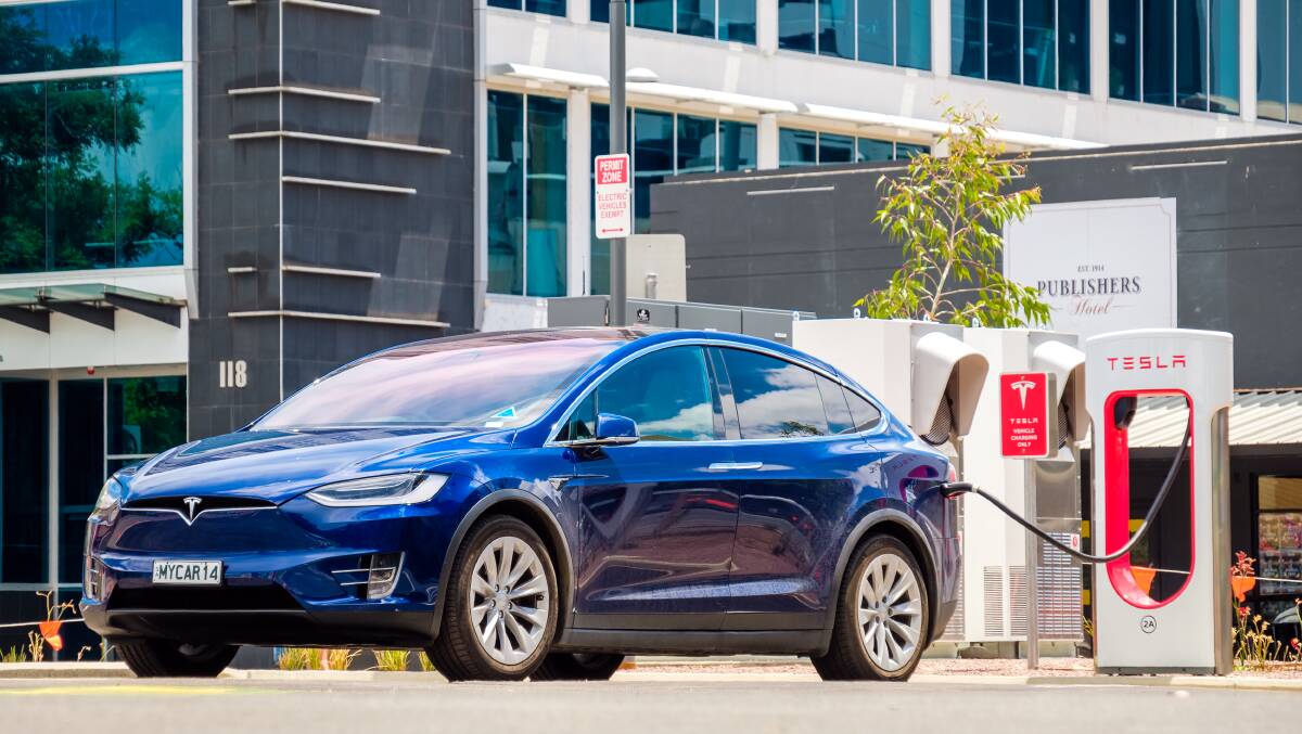 A Tesla Model X charges on a Tesla charging station in the Adelaide CBD. Electric cars are notably more expensive in Australia than in comparable markets overseas. Picture: Shutterstock