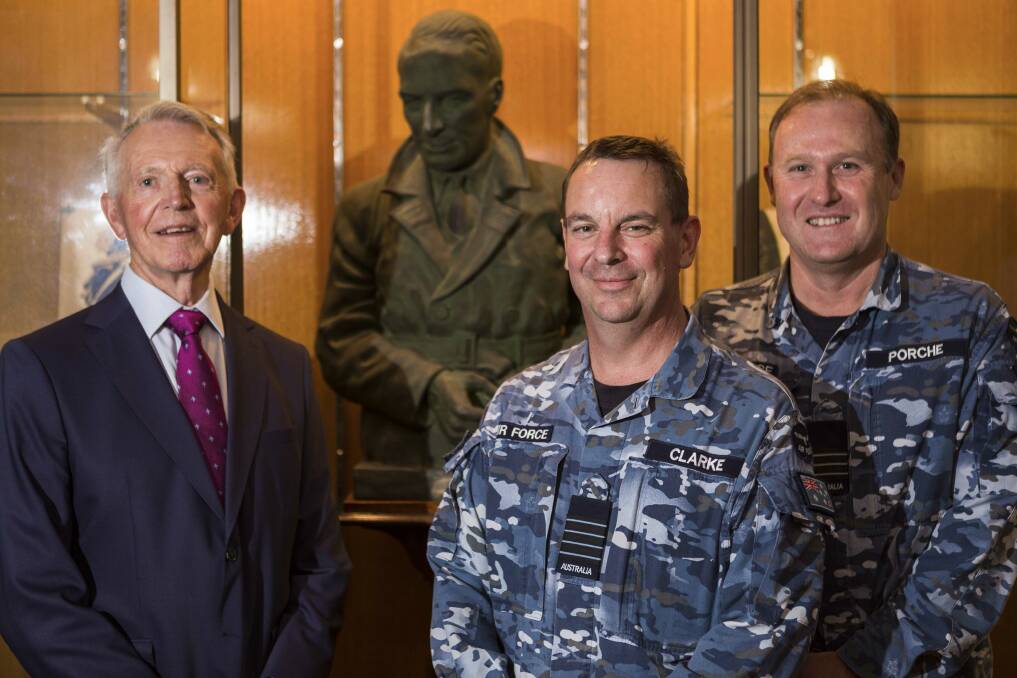 Dr Lawrence Kingsford Sayer, Group Captain Bradley Clarke, Chief of Staff, Air Mobility Group and Chairman of the Mess Committee Wing Commander Greg Porche stand in front of a bust of Sir Charles Kingsford Smith that was donated to the RAAF Base Richmond Officers mess. Picture: Defence Australia.