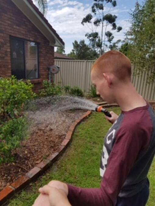 Paul watering his garden.