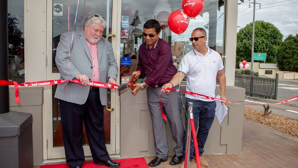 Mayor Kim Ford, with owners Rudra Paudel and Sailesh Vasudewan at the opening of the Windsor Red Rooster last weekend.