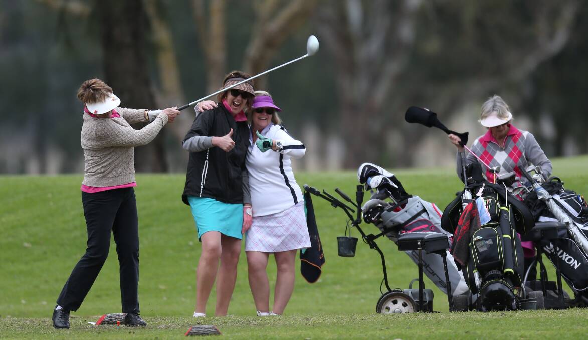 As one woman tees off in 2016 during the Hawkesbury Classic, others show how much fun they were having on the day. Picture: Geoff Jones
