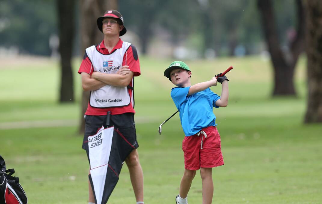 BONDING TIME: Tom Daniels watches son Harry play a shot.