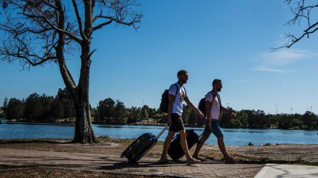 Polish tourists Tom and Andrew walking from Wolli Creek station to Sydney Airport. Photo: Louise Kennerley