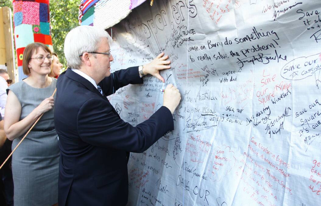 Labor candidate for Macquarie Susan Templeman looks on as Prime Minister Kevin Rudd signs the CAWB tent which has been occupied for 47 days today. Picture: Carlos Furtado