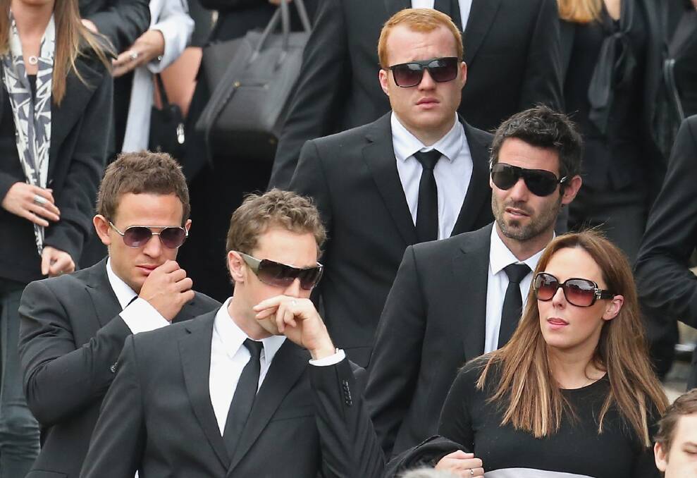 Alan Didak,Nick Maxwell and Luke Ball of the Magpies look on as the coffin is carried from the church after the funeral service for John McCarthy at St Mary's Star of the Sea Catholic Church on September 20, 2012 in Sorrento, Australia. Port Adelaide AFL player John McCarthy died at the Flamingo Hotel and Casino in Las Vegas during a player end of season holiday. (Photo by Scott Barbour/Getty Images) 