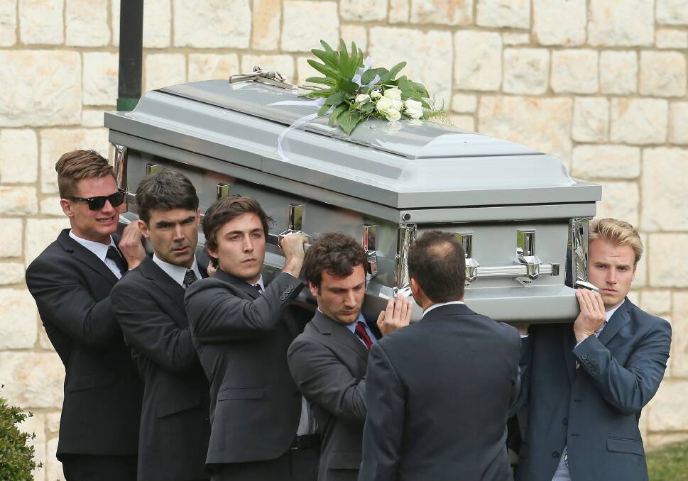 The coffin is carried by pall-bearers after the funeral service for John McCarthy at St Mary's Star of the Sea Catholic Church on September 20, 2012 in Sorrento, Australia. Port Adelaide AFL player John McCarthy died at the Flamingo Hotel and Casino in Las Vegas during a player end of season holiday. (Photo by Scott Barbour/Getty Images) 