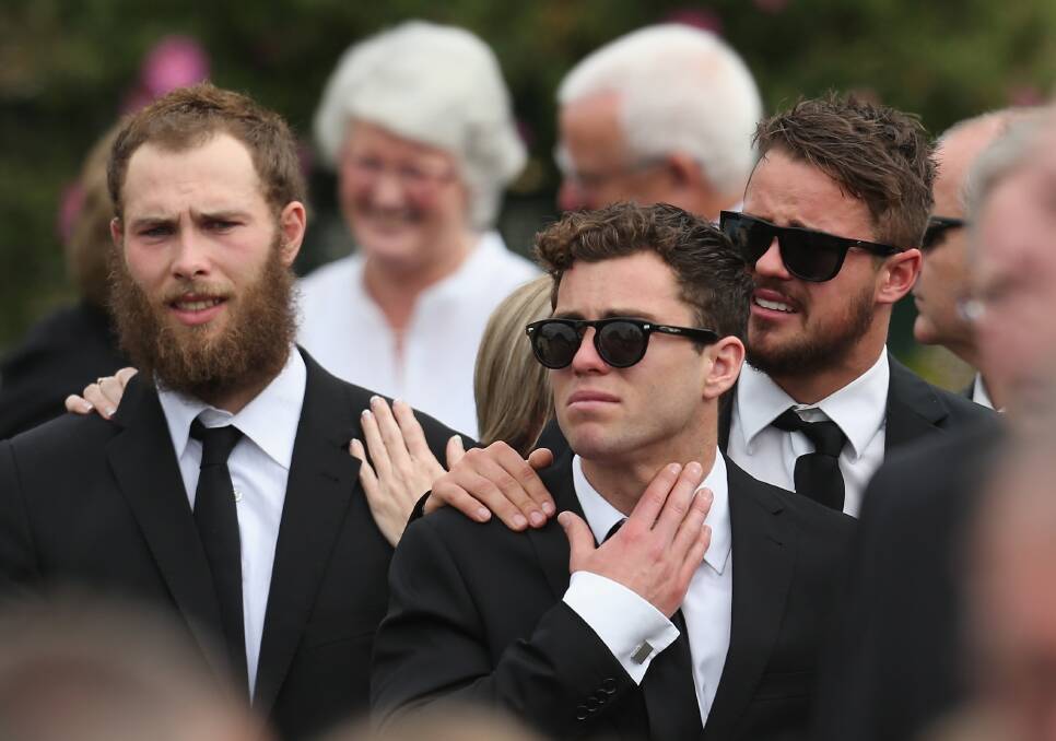 Brent Macaffer and Jarryd Blair of the Magpies look on as the coffin is carried from the church after the funeral service for John McCarthy at St Mary's Star of the Sea Catholic Church on September 20, 2012 in Sorrento, Australia. Port Adelaide AFL player John McCarthy died at the Flamingo Hotel and Casino in Las Vegas during a player end of season holiday. (Photo by Scott Barbour/Getty Images) 
